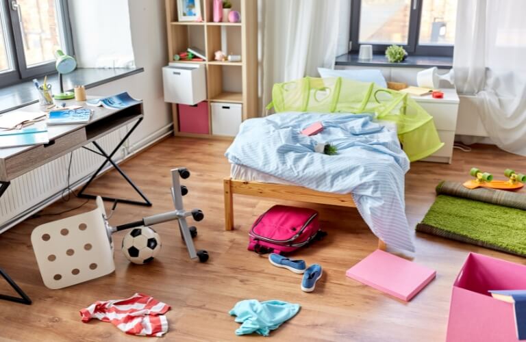 Bedroom with things laying on the floor